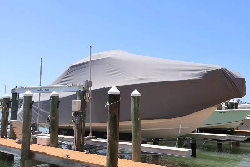 Slide: The Image of Covered 2021 Grady-White Canyon 336 boat docked on a sunny day. - 15
