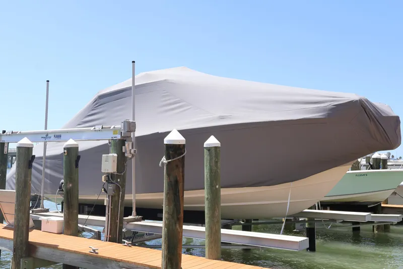 Slide: The Image of 2021 Grady-White Canyon 336 boat covered at dock, sunny day. - 16