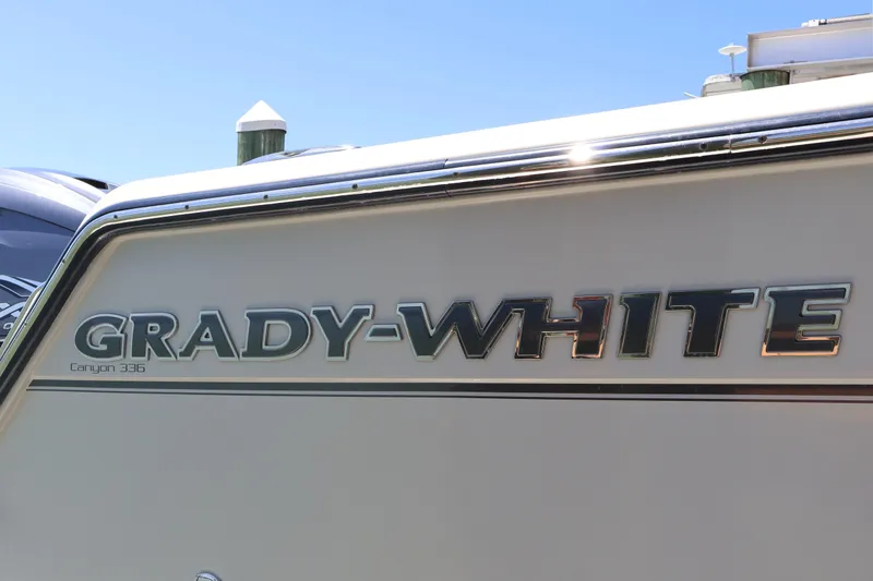 Slide: The Image of 2021 Grady-White Canyon 336 boat logo on side view under clear sky. - 17