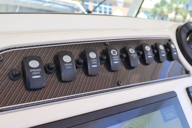 Slide: The Image of Control panel of 2021 Grady-White Canyon 336 boat with labeled switches. - 28