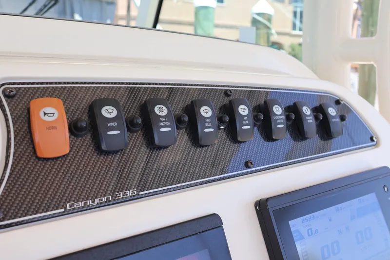 Slide: The Image of Control panel of 2021 Grady-White Canyon 336 boat with labeled switches. - 29