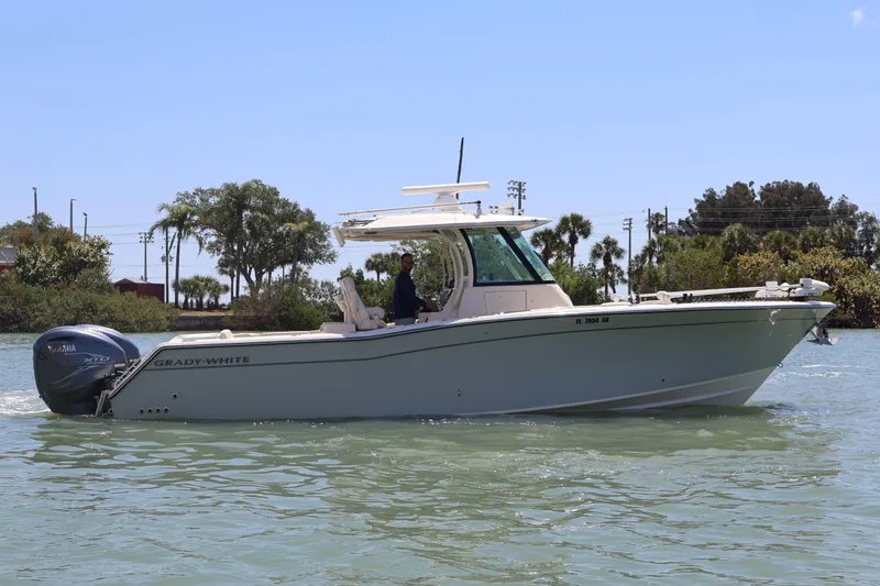 Slide: The Image of 2021 Grady-White Canyon 336 boat cruising on a sunny day. - 3