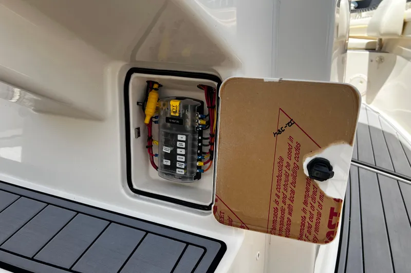 Slide: The Image of Electrical panel on a 2021 Grady-White Canyon 336 boat, with open access cover. - 36