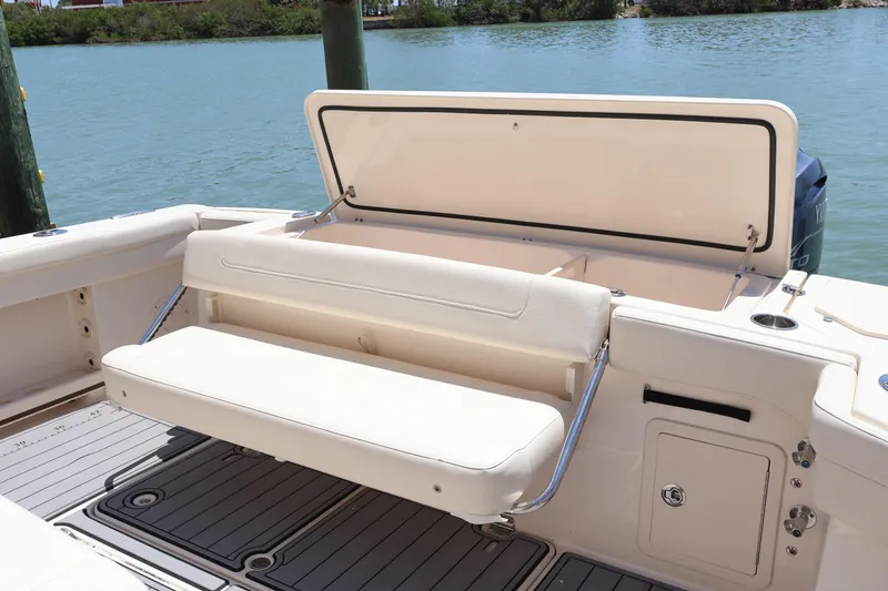 Slide: The Image of 2021 Grady-White Canyon 336 boat with foldable seating and storage, docked by the water. - 44