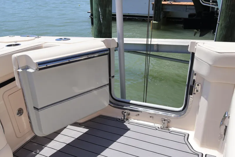 Slide: The Image of 2021 Grady-White Canyon 336 boat with open transom door, docked by the water. - 49