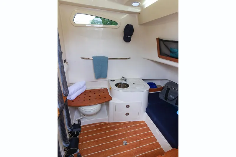 Slide: The Image of Manufacturer Provided Image: 2021 Grady-White Canyon 336 boat interior with wooden flooring and compact amenities. - 53