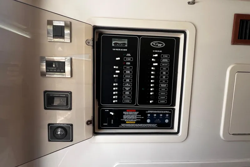 Slide: The Image of Control panel of a 2021 Grady-White Canyon 336 boat, featuring electrical switches and gauges. - 56