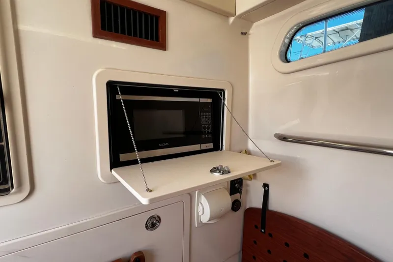 Slide: The Image of Interior of 2021 Grady-White Canyon 336 boat featuring a built-in microwave. - 66