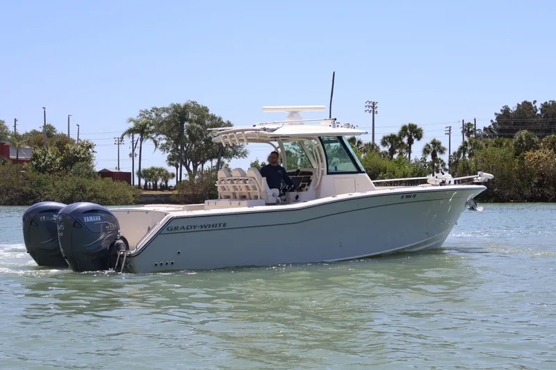 Slide: The Image of 2021 Grady-White Canyon 336 boat cruising on a sunny day with twin Yamaha engines. - 7