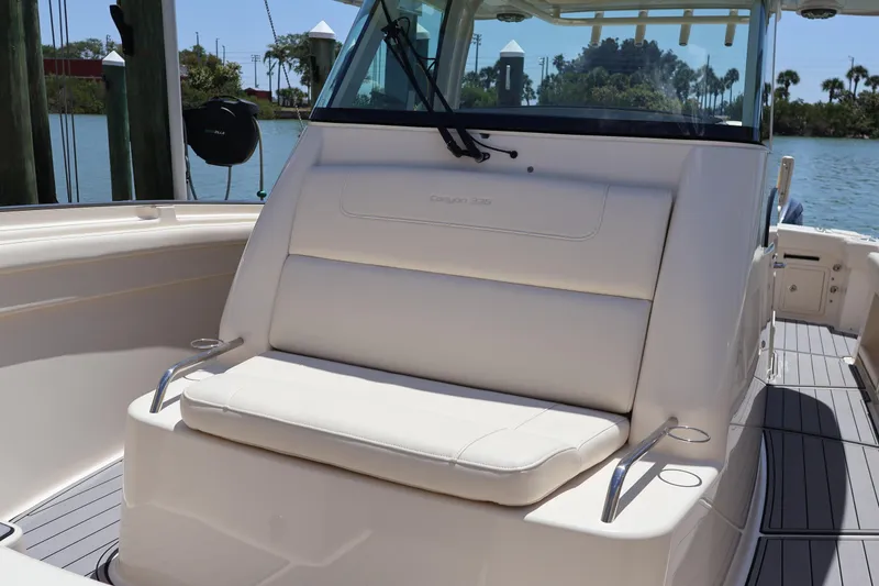 Slide: The Image of 2021 Grady-White Canyon 336 boat interior with cushioned seating and sleek design. - 79