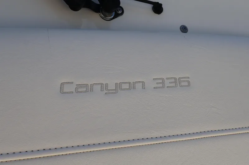 Slide: The Image of 2021 Grady-White Canyon 336 boat logo on white surface. - 80