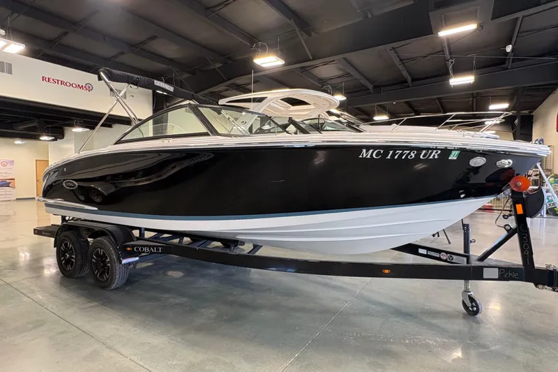 The Image of 2021 Cobalt CS23 boat on trailer in indoor showroom setting. - 0
