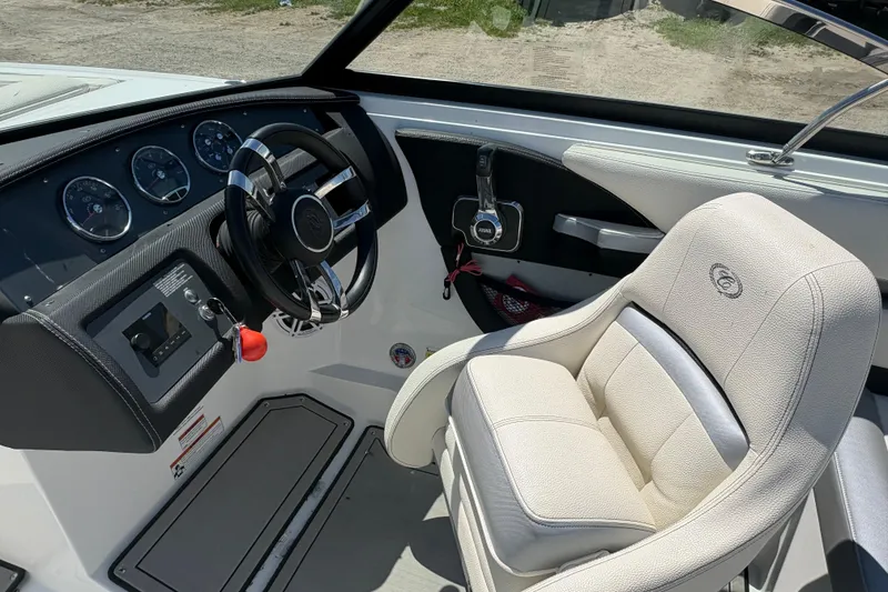 Slide: The Image of Interior of 2021 Cobalt CS23 boat with steering wheel and captain's seat. - 11