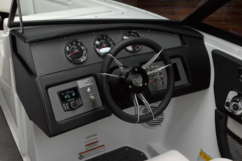 Slide: The Image of Manufacturer Provided Image: 2021 Cobalt CS23 boat dashboard with steering wheel and control gauges. - 12