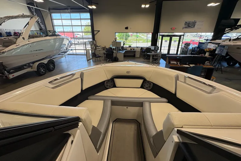 Slide: The Image of 2021 Cobalt CS23 boat interior in showroom with luxury seating and modern design. - 15