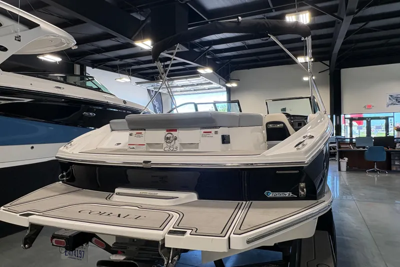 Slide: The Image of 2021 Cobalt CS23 boat in showroom, featuring sleek design and spacious seating. - 2