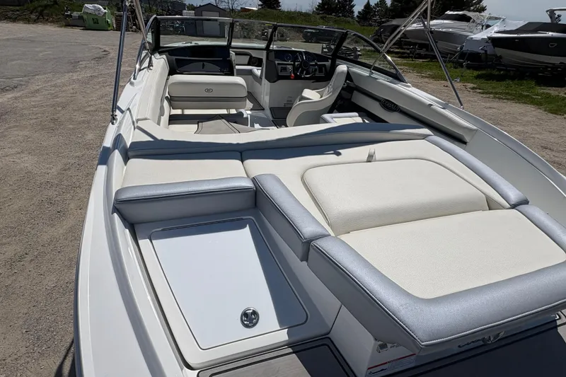 Slide: The Image of 2021 Cobalt CS23 boat interior with white seating and dashboard view. - 4