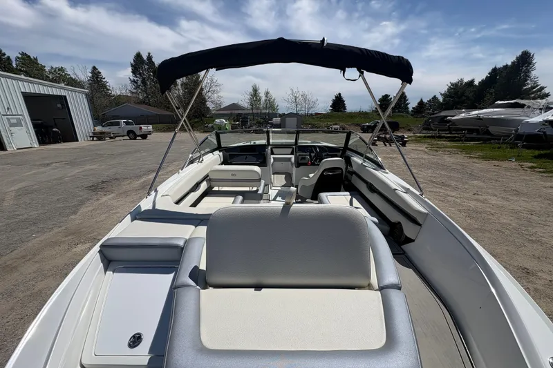 Slide: The Image of 2021 Cobalt CS23 boat with canopy, parked outdoors on a sunny day. - 5