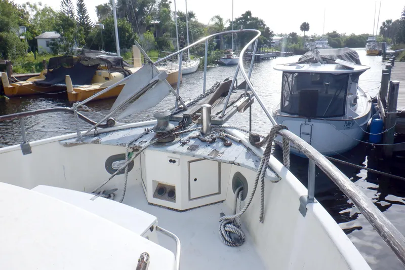 Slide: The Image of 1980 Grand Banks 49 Classic yacht docked, featuring deck and mooring ropes. - 12