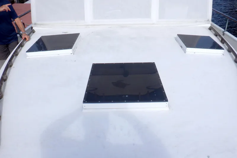 Slide: The Image of Rooftop view of 1980 Grand Banks 49 Classic yacht with three black hatches. - 14