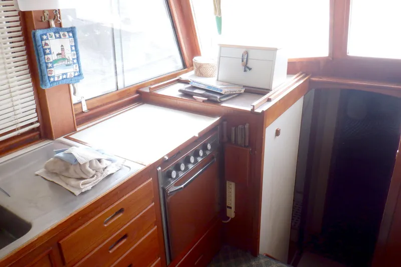 Slide: The Image of Interior of 1980 Grand Banks 49 Classic yacht kitchen with wooden cabinetry and appliances. - 20