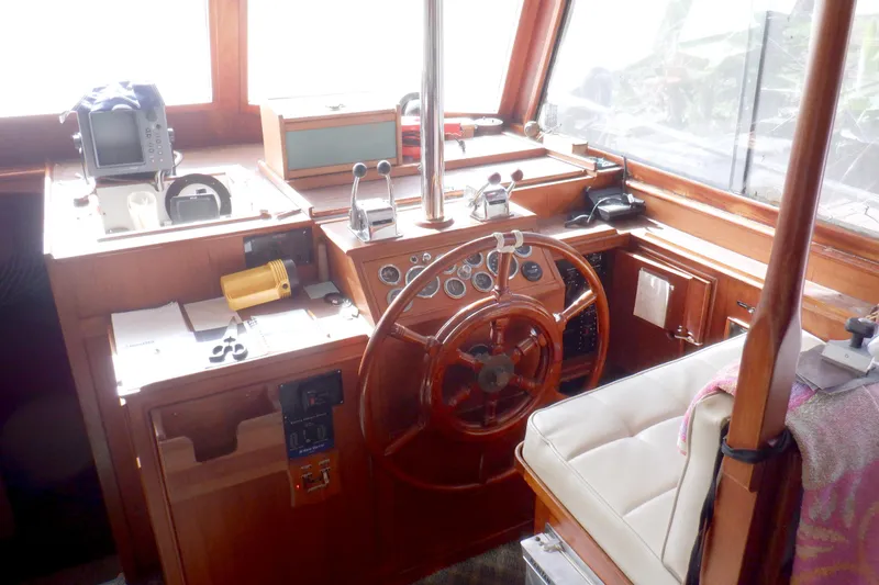 Slide: The Image of Helm of 1980 Grand Banks 49 Classic yacht with wooden steering wheel and navigation equipment. - 21