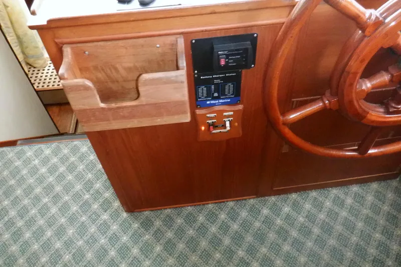 Slide: The Image of Wooden helm station of 1980 Grand Banks 49 Classic yacht with steering wheel and control panel. - 26