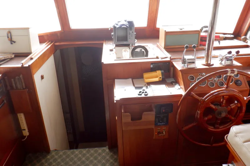 Slide: The Image of 1980 Grand Banks 49 Classic helm with wooden wheel and navigation equipment. - 28