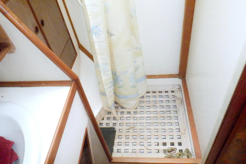Slide: The Image of Shower area in a 1980 Grand Banks 49 Classic boat with wooden accents. - 29