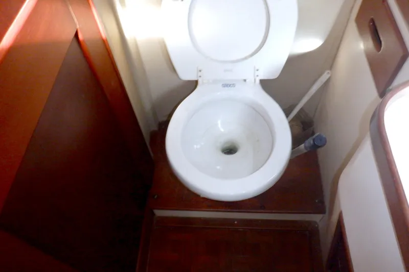 Slide: The Image of Toilet in 1980 Grand Banks 49 Classic yacht bathroom, featuring wooden accents. - 30