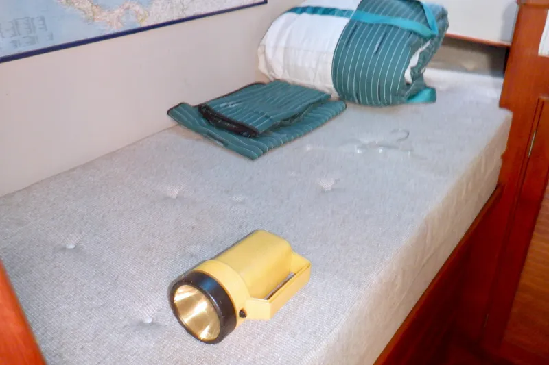 Slide: The Image of Cozy cabin bed with flashlight on 1980 Grand Banks 49 Classic yacht. - 32