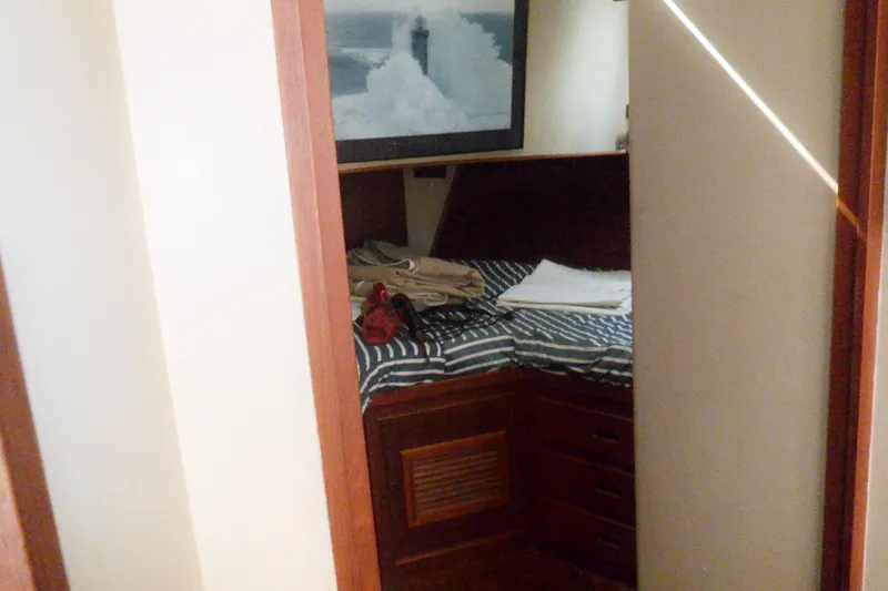 Slide: The Image of Cozy cabin interior of 1980 Grand Banks 49 Classic yacht with striped bedding. - 33