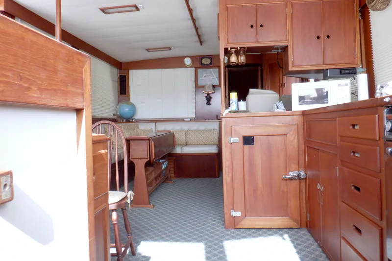 Slide: The Image of Interior of 1980 Grand Banks 49 Classic yacht with wooden cabinetry and seating area. - 35
