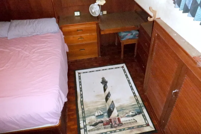 Slide: The Image of Cozy cabin interior of 1980 Grand Banks 49 Classic with bed, desk, and lighthouse rug. - 37