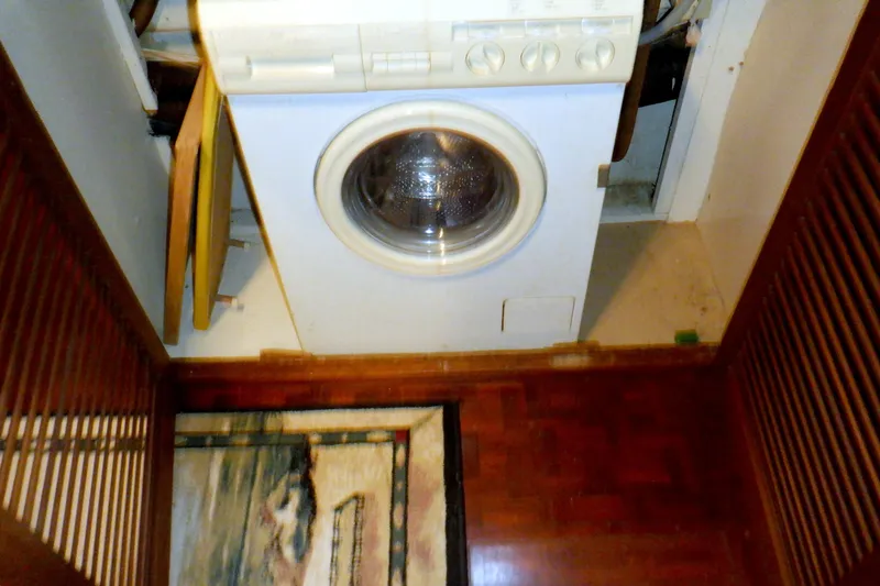 Slide: The Image of Laundry area on a 1980 Grand Banks 49 Classic yacht with a front-loading washing machine. - 38