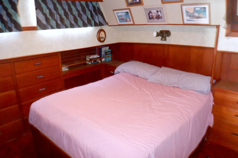 Slide: The Image of Cozy bedroom interior of 1980 Grand Banks 49 Classic yacht with wood paneling and pink bedding. - 39