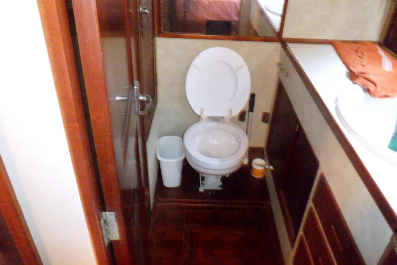 Slide: The Image of Bathroom interior of 1980 Grand Banks 49 Classic yacht, featuring toilet and wooden cabinetry. - 41