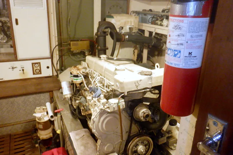 Slide: The Image of Engine room of a 1980 Grand Banks 49 Classic yacht with visible fire extinguisher. - 43