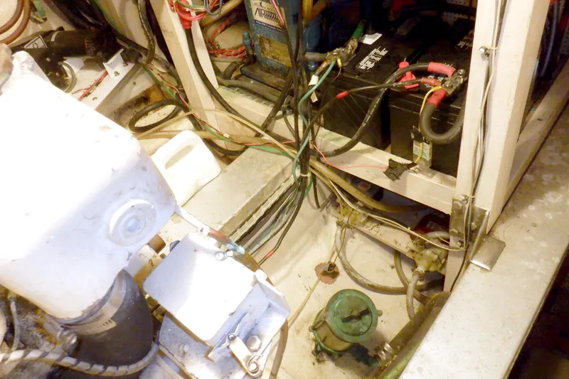 Slide: The Image of Engine room of a 1980 Grand Banks 49 Classic with visible wiring and batteries. - 45