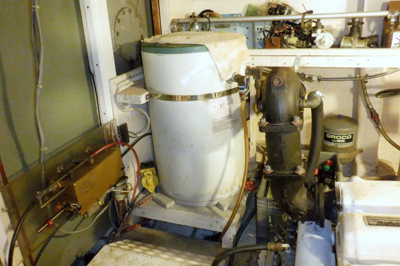 Slide: The Image of Engine room of a 1980 Grand Banks 49 Classic yacht, featuring mechanical components. - 47