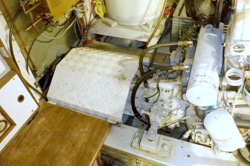 Slide: The Image of Engine room of 1980 Grand Banks 49 Classic yacht, showcasing mechanical components and wiring. - 48