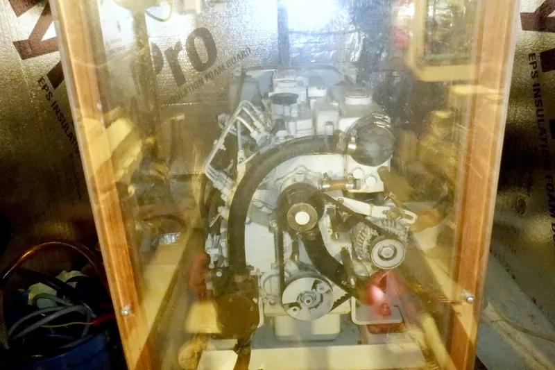 Slide: The Image of Engine room of a 1980 Grand Banks 49 Classic yacht, showcasing mechanical components. - 49