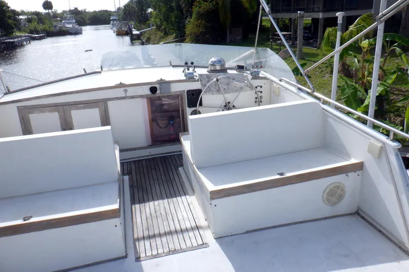 Slide: The Image of Upper deck of a 1980 Grand Banks 49 Classic yacht with seating and steering wheel. - 5