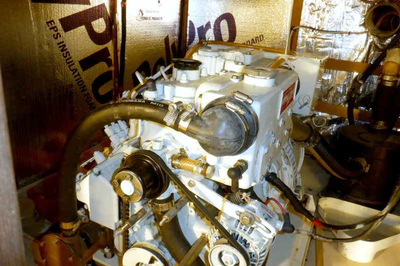 Slide: The Image of Engine room of a 1980 Grand Banks 49 Classic yacht, featuring mechanical components. - 50