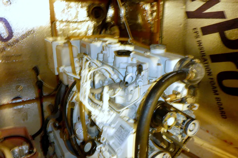 Slide: The Image of Engine room of a 1980 Grand Banks 49 Classic yacht, showcasing mechanical components. - 51