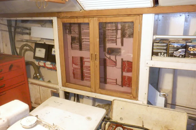 Slide: The Image of Engine room of 1980 Grand Banks 49 Classic with organized wiring and storage. - 54