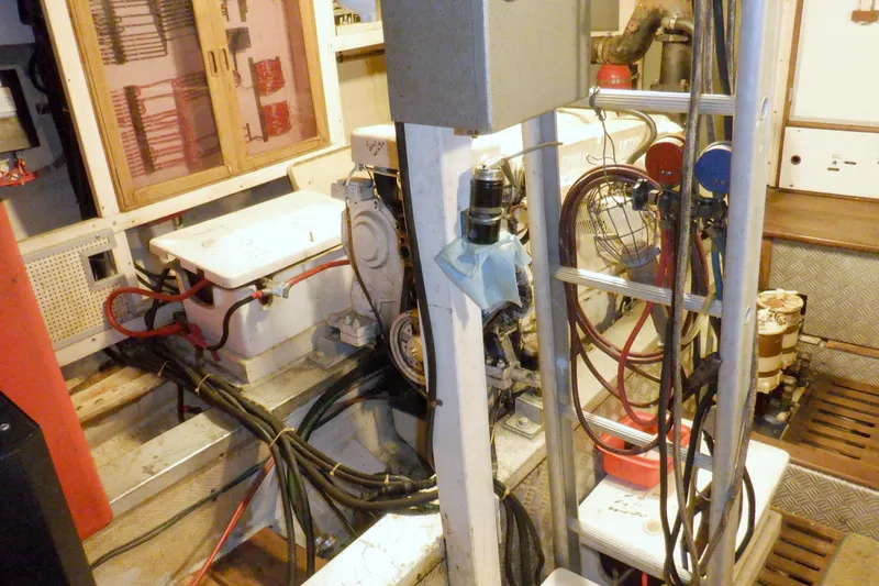 Slide: The Image of Engine room of a 1980 Grand Banks 49 Classic yacht, showcasing mechanical components. - 58