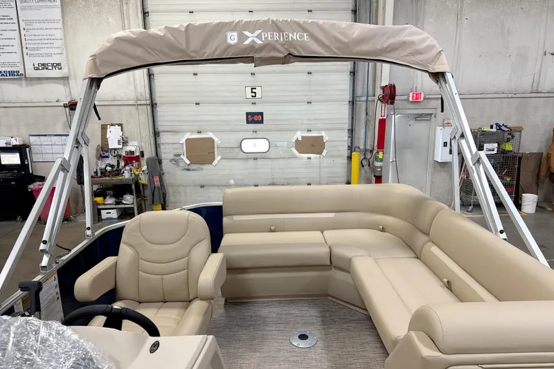 Slide: The Image of 2026 Godfrey EX 1880 CX pontoon boat interior with beige seating and canopy. - 10