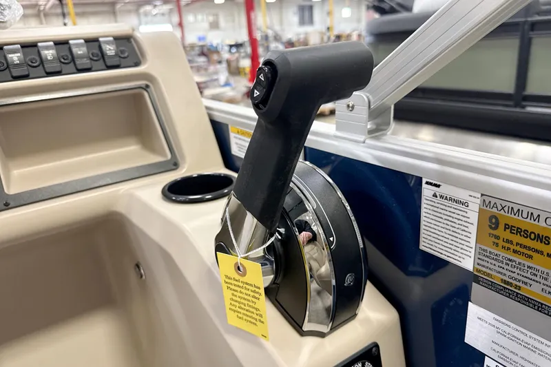 Slide: The Image of Control panel of a 2026 Godfrey EX 1880 CX boat with throttle lever and warning labels. - 6