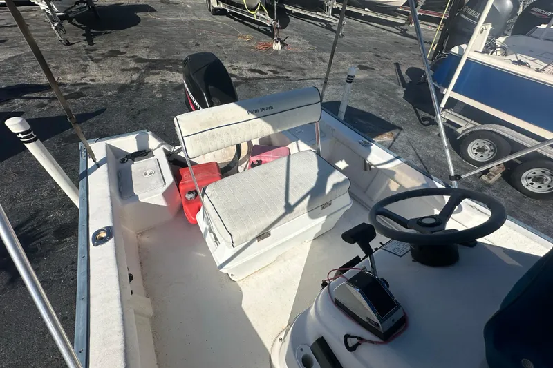 Slide: The Image of 2004 Palm Beach 161 Whitecap boat interior with steering wheel and seating. - 4